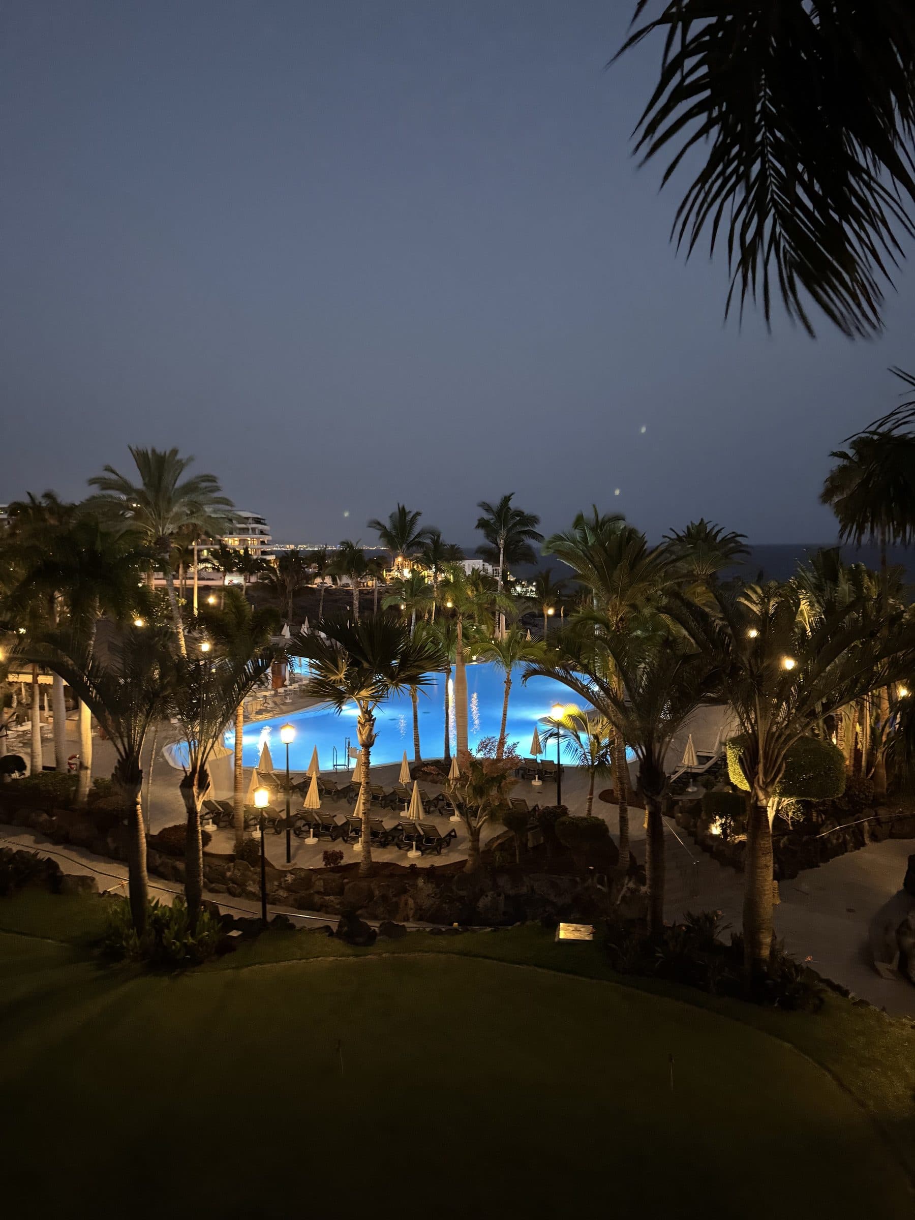 Roca Nivaria at night — the illuminated pool, palm trees and hotel grounds in Playa Paraiso.