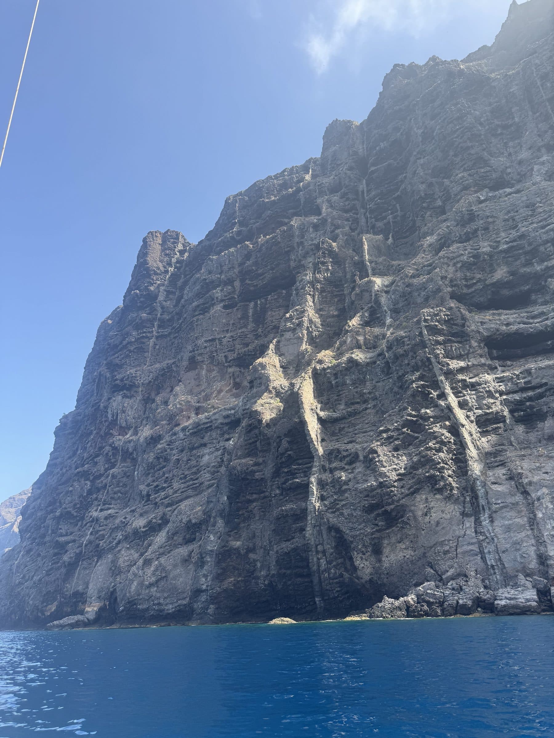 Looking straight up at the sheer cliff face of Los Gigantes rising from the sea.